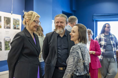 Zdjęcie grupy osób na tle wystawy. Na pierwszym planie dwie kobiety i mężczyzna podczas rozmowy, uśmiechają się. Na zdjęciu od lewej: prof. M.Kłos, arch. W. Matłok, dr arch. B. Walicka-Góral.